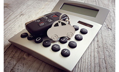 Car shaped keyring on top of calculator