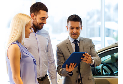 Automotive car sales agent showing a loan to lessee