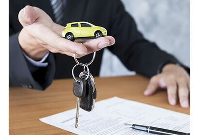 Signing a lease contract for a Car, with Keys to your dream Vehicle